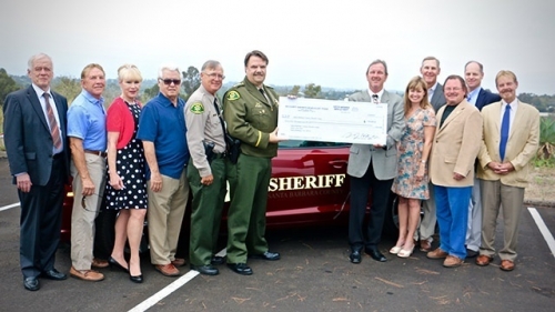 posse supporters posing with the donation check